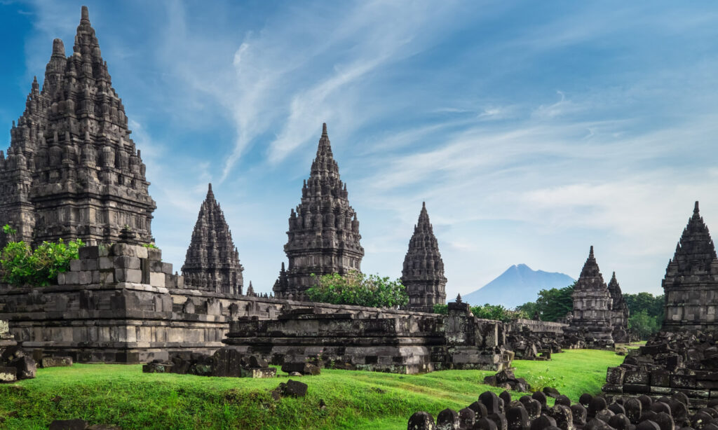 Ancient,Stone,Ruins,On,Green,Field,And,Candi,Prambanan,Or