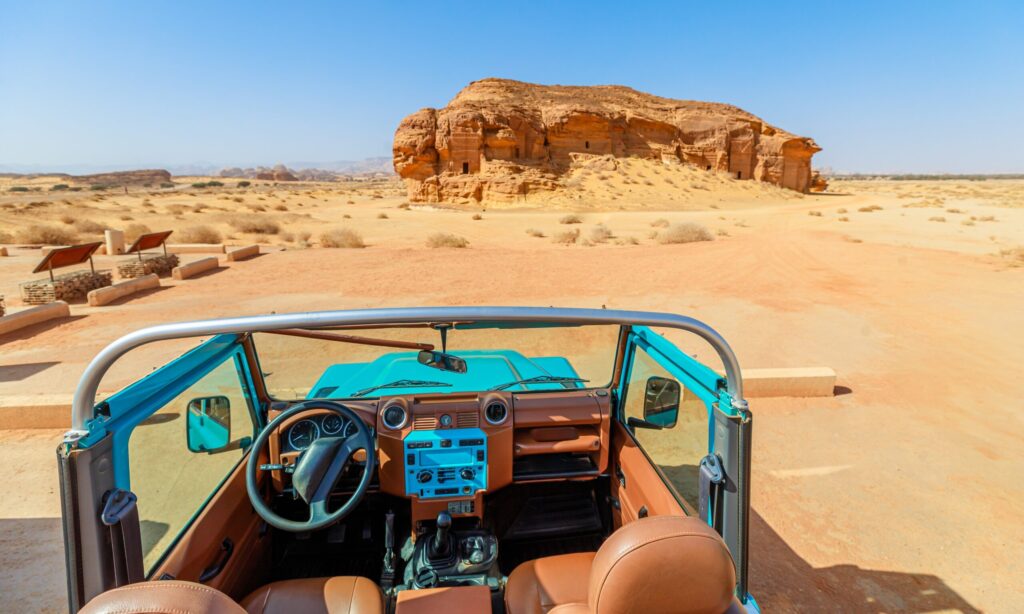 Turquoise,Suv,Beside,Ancient,Rock-cut,Tombs,Jabal,Al-ahmar,At,The